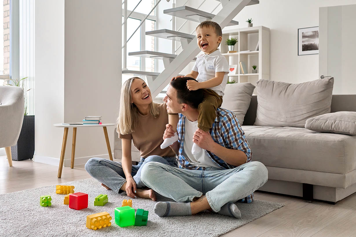 Happy,Young,Family,Couple,Having,Fun,Playing,With,Happy,Cute Happy young family couple having fun playing with happy cute kid sitting on dad's shoulders in modern living room