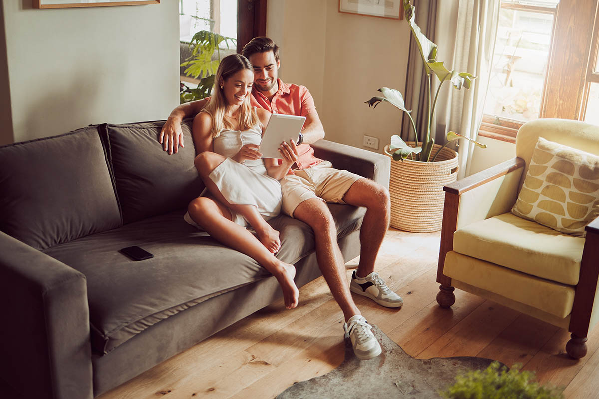 Shot of a young couple using a digital tablet together at home.